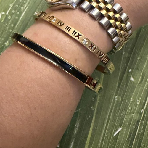 Set of 2 steel bracelets with gold and black details, new