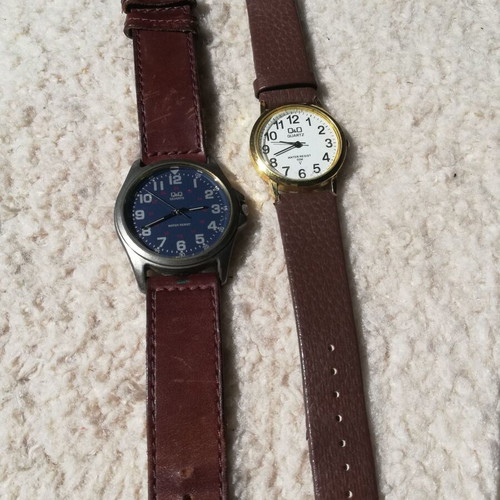 Q&Q wristwatches used with brown leather straps, blue one has glass damage