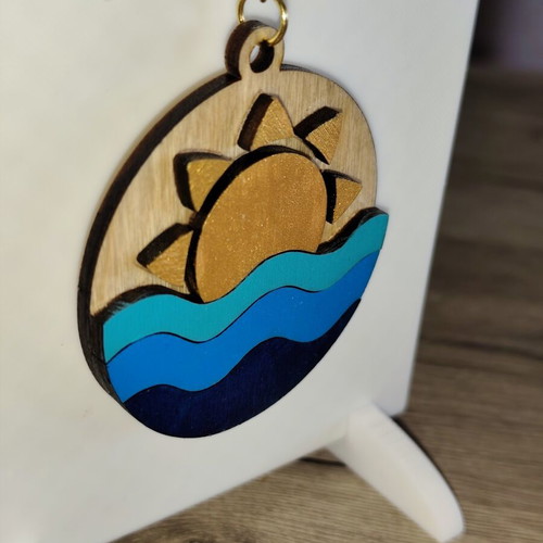 Handmade wooden summer keychain with laser cut sun and waves design