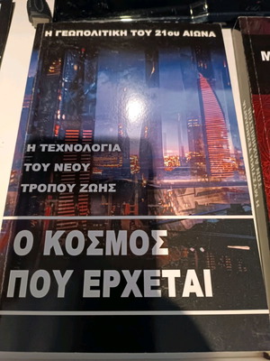 O kosmos pou erchetai used book