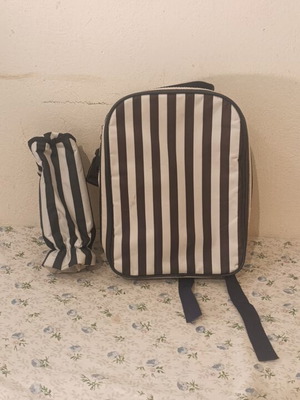 Insulated backpack with bottle holder like new, black and white striped