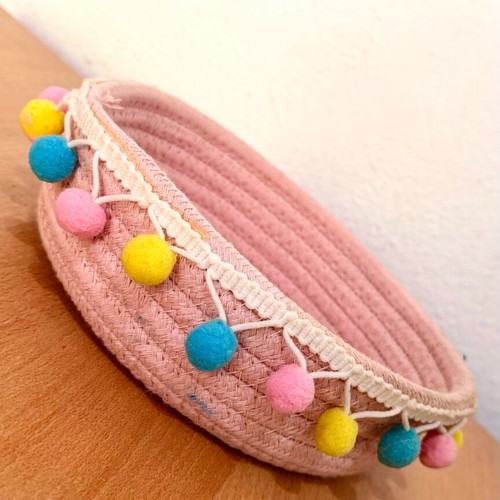 Handmade pink basket with colorful pom poms like new