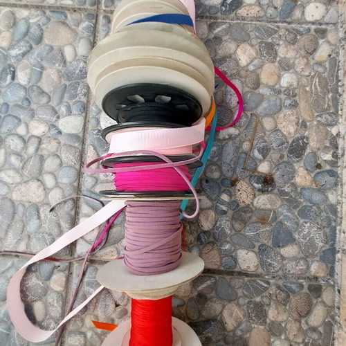 Wooden base with ribbons used for jewelry