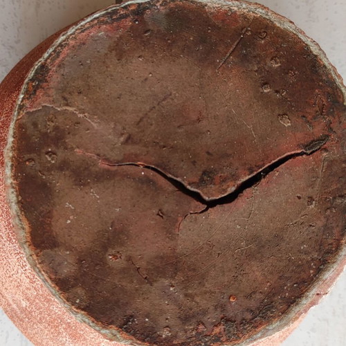 Clay flowerpot used with crack at base