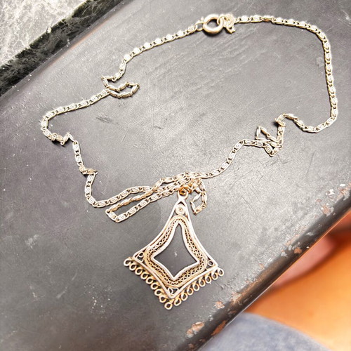 Silver vintage pendant with intricate chain