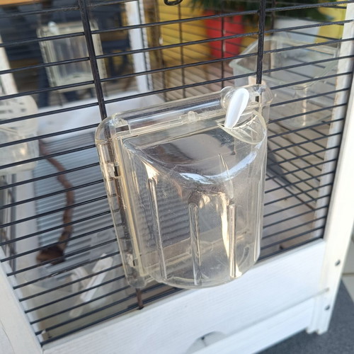 Wooden birdcage used with steel bars and plastic door