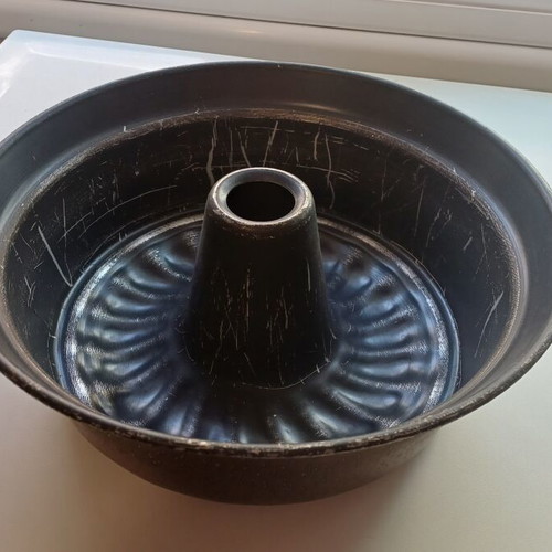 Large cake pan used with visible signs of wear