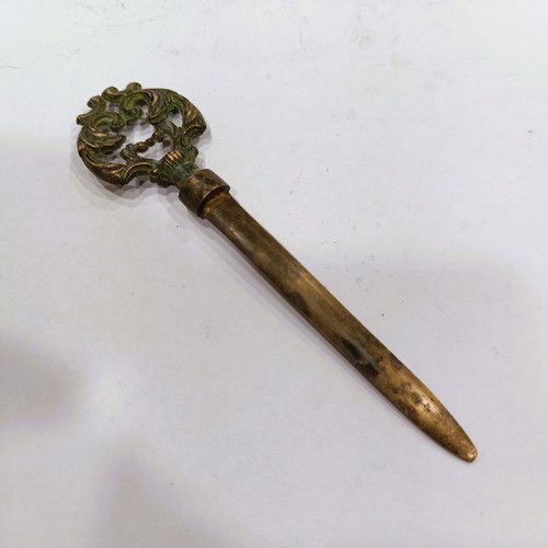 Vintage brass letter opener with embossed baroque handle, used