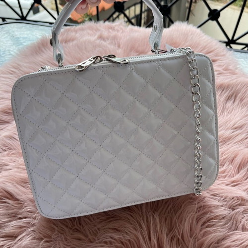 White lustrous bag with silver details and chain