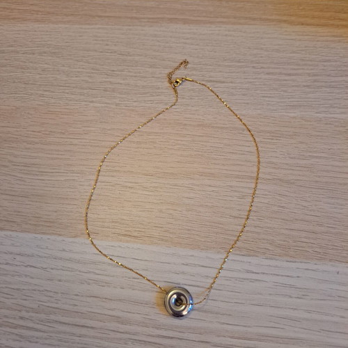 Necklace with gold tone chain and silver round pendant like new
