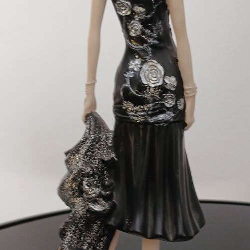 Decorative figurine of a girl with rose dress