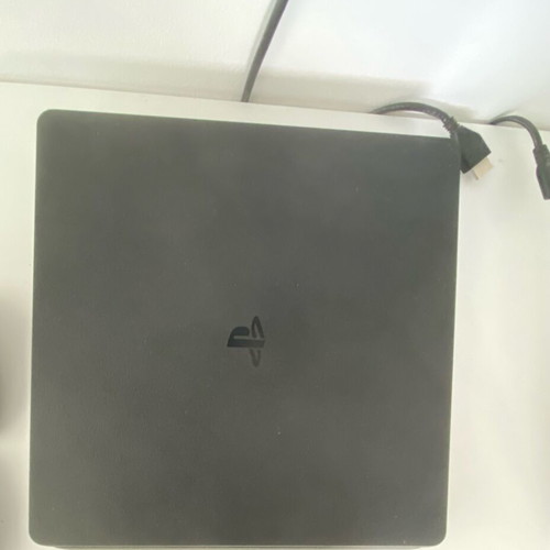 PlayStation 4 Slim 500GB used with 2 controllers and 4 games