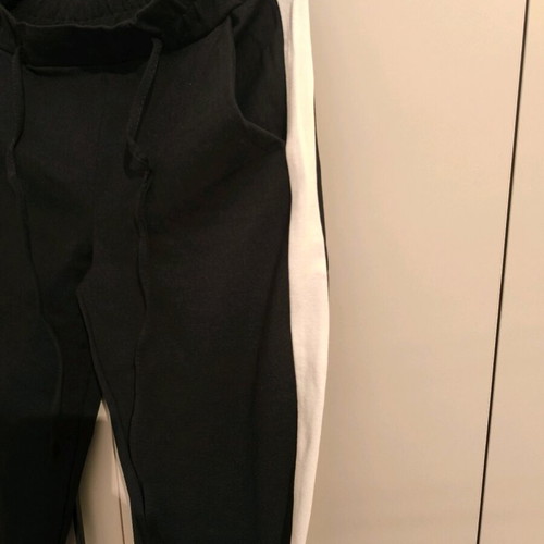 sweatpants with a white stripe on the side and an elastic waistband