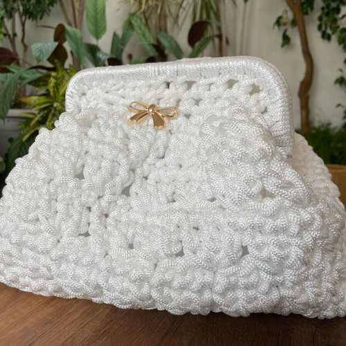 Handmade white shoulder bag with gold bow and clasp