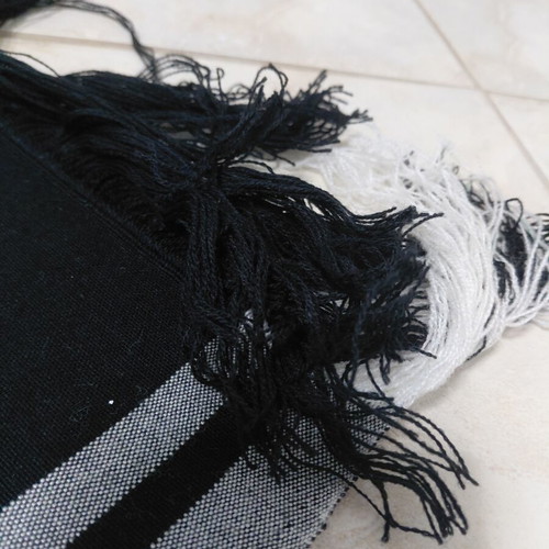 Traditional cotton fabric on loom, new, black with gray stripes and fringes