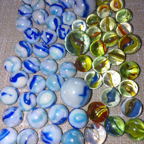 Collection of 68 used glass marbles in various sizes