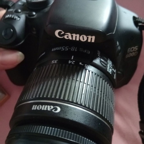 Canon EOS600D camera with 18-55mm lens, strap, charger, and two batteries