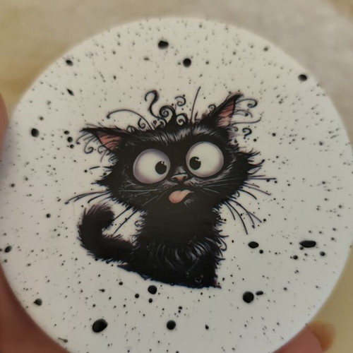 Handmade coasters with black base and 4 playful cat designs