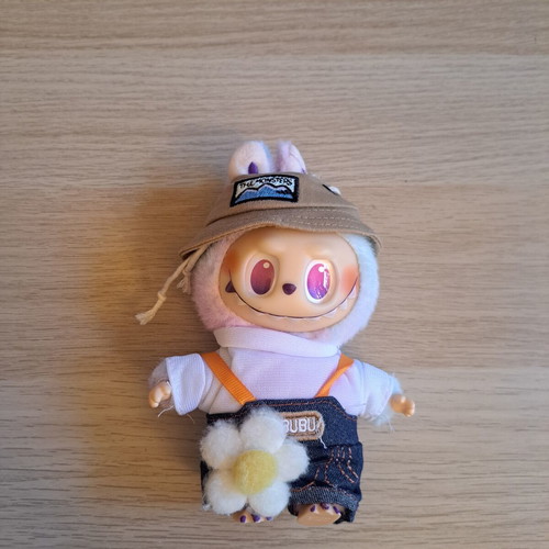 Labubu doll with pastel pink, purple, and blue clothes like new