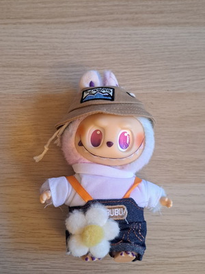 Labubu doll with pastel pink, purple, and blue clothes like new