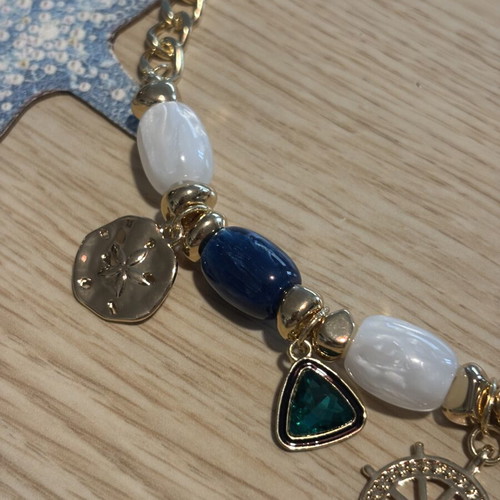 Statement necklace with blue and gold sea charms
