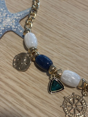 Statement necklace with blue and gold sea charms
