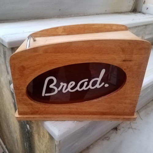 Wooden breadbox with hinged lid and metal handle used