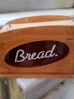 Wooden breadbox with hinged lid and metal handle used