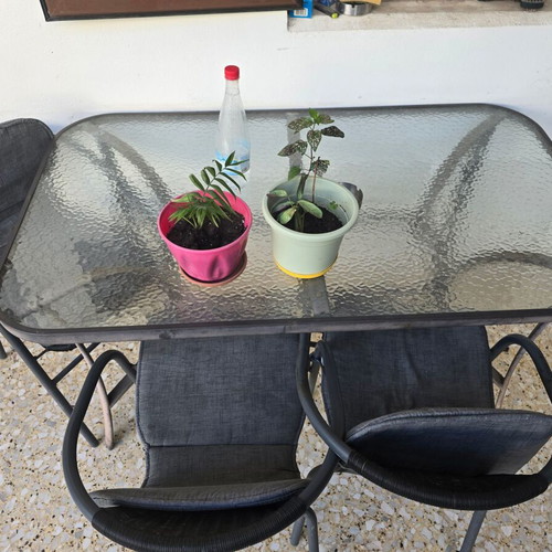 Outdoor dining set used with glass table and 4 chairs