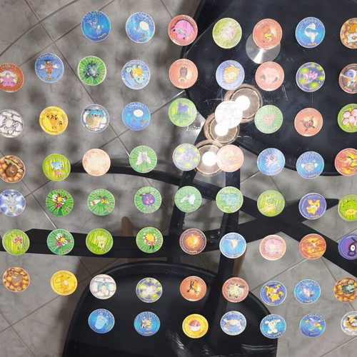 Pokemon Tazos used with visible wear