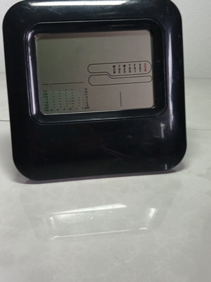 Digital table clock used with temperature display
