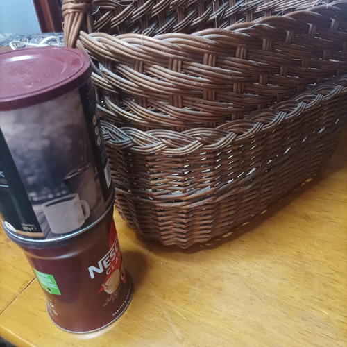 Handmade dark brown wicker basket with high arched handle