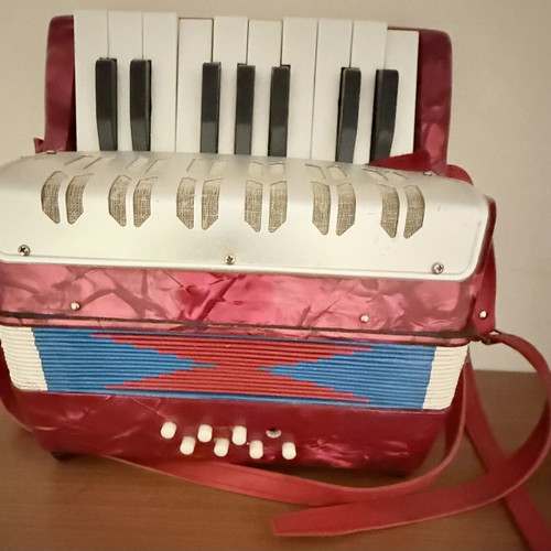 Children's accordion used, red with blue and red bellows