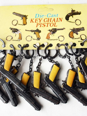 Card with 12 vintage 80's Colt 45 metal pistol keychains new
