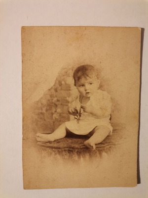 Old photo portrait of a small child with Bechtsis photographer stamp