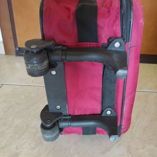 Red fabric travel suitcase trolley carry-on