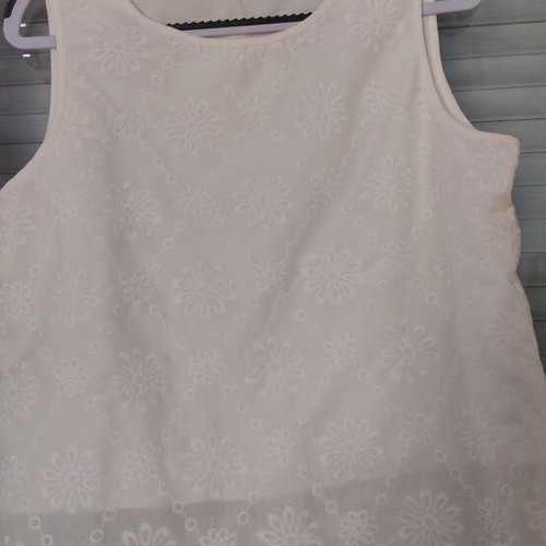 White sleeveless blouse with embroidered flowers