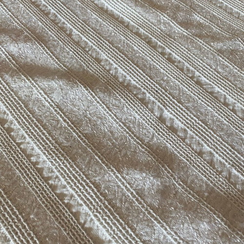 Woven cotton bedspread used with handmade lace trim