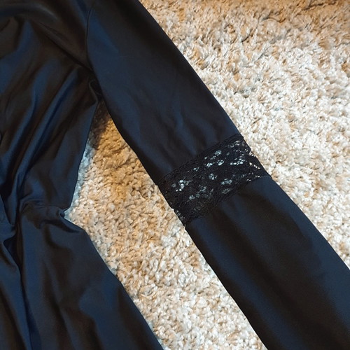 Black crossover dress used with delicate lace trim