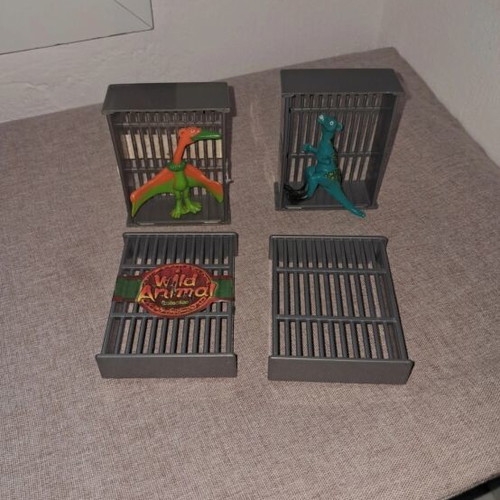 Dinosaur figures used, set in cages