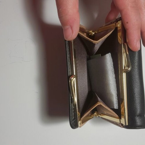 Black wallet new with gold emblem and beige lining