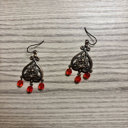Earrings used with red plastic beads and bronze metal