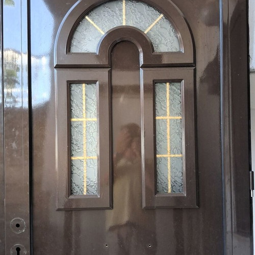 Two brown aluminum entrance doors with frames, handles and locks