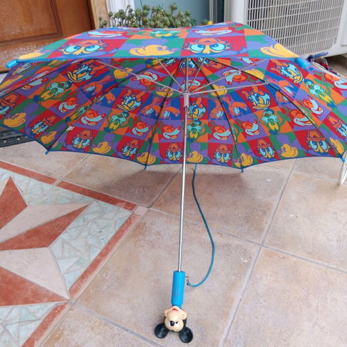 Disney umbrella used with blue Mickey Mouse handle, multicolored