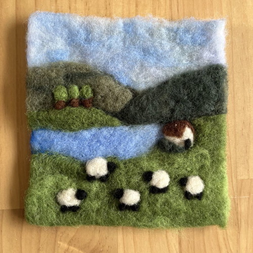 Handmade wool felt landscape picture with sheep