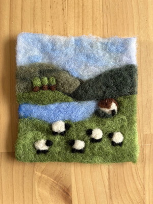 Handmade wool felt landscape picture with sheep