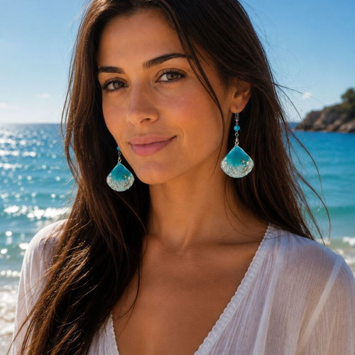 Handmade earrings with stars, shells, pearls, and crystals in resin