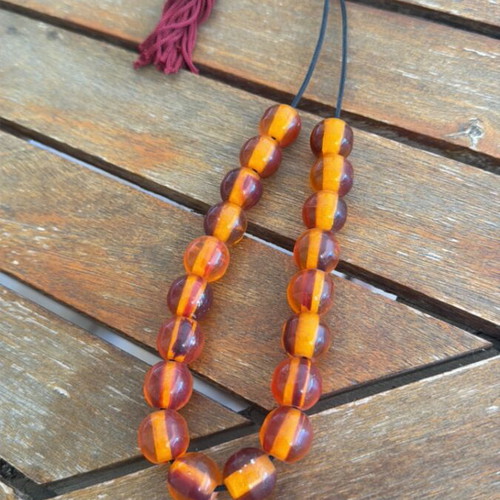 Worry beads used, large with brown orange beads and burgundy tassel