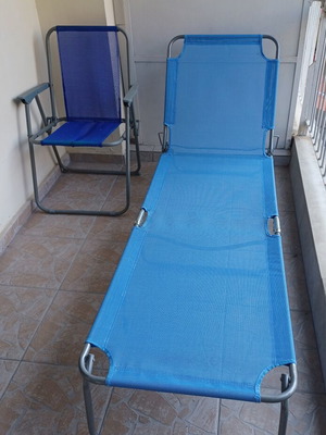 New beach lounger with used chair