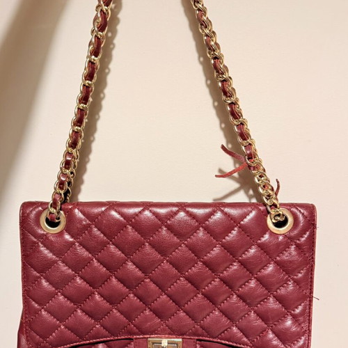 Italian leather shoulder bag used with wear on corners and chain